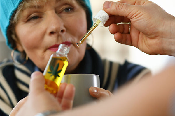 Senior Woman being given CBD tincture