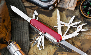 Swiss Army Knife sitting on a table with other survival items